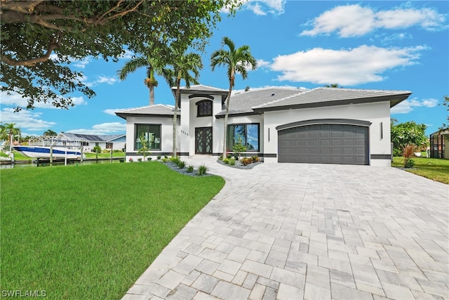 view of front of home featuring a garage and a front yard