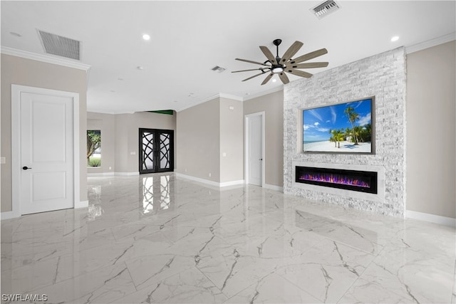 unfurnished living room featuring ceiling fan, a large fireplace, and ornamental molding