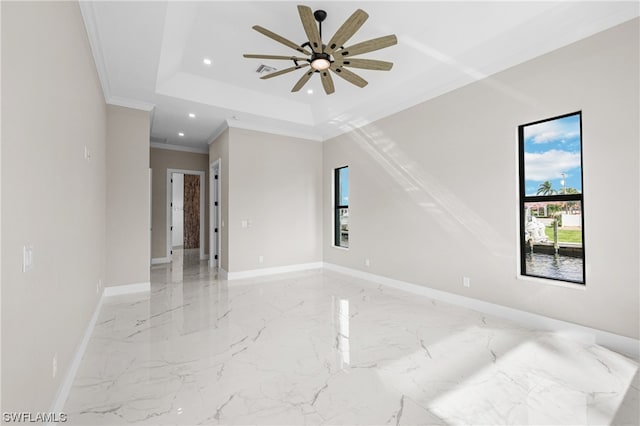 unfurnished room featuring ceiling fan, a raised ceiling, and crown molding