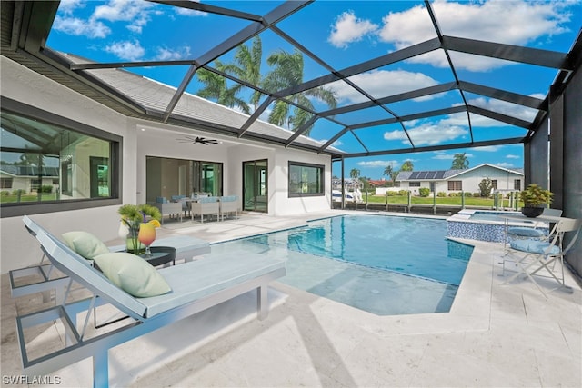 view of swimming pool with an in ground hot tub, a patio, glass enclosure, and ceiling fan