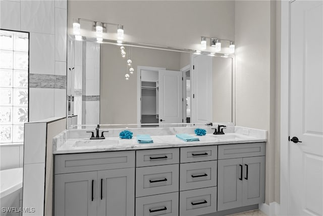 bathroom with vanity and a bath