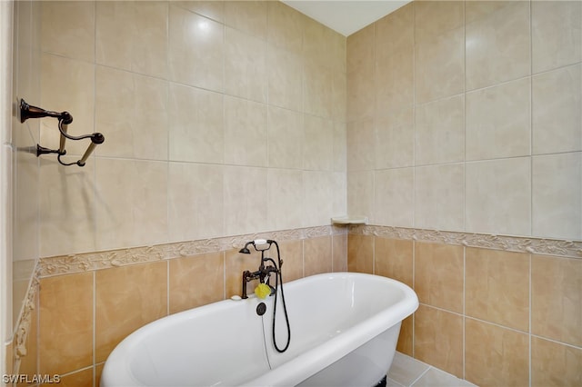 bathroom with tile walls, tile floors, and a bath