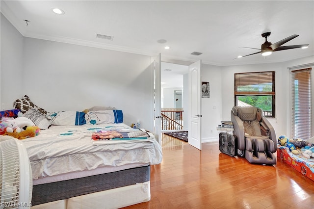 bedroom with crown molding, ceiling fan, and light hardwood / wood-style flooring