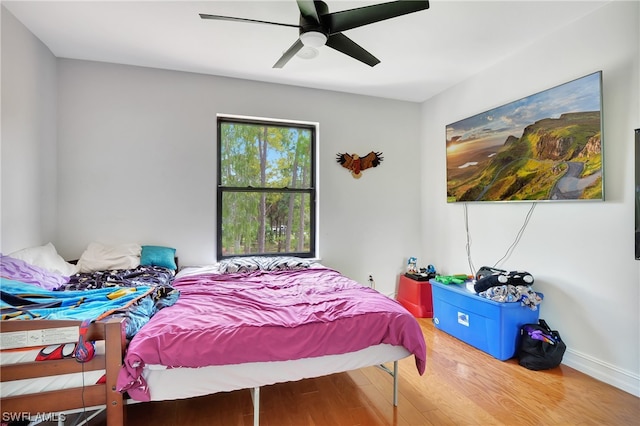 bedroom with hardwood / wood-style floors and ceiling fan