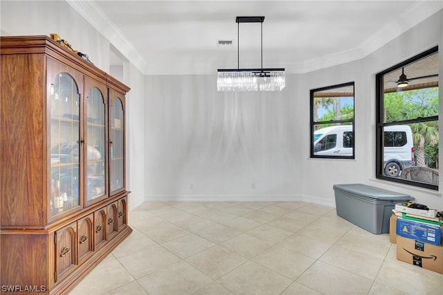 dining room with light tile flooring, a notable chandelier, and crown molding