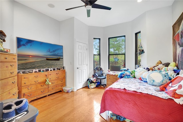 bedroom with ceiling fan and light wood-type flooring