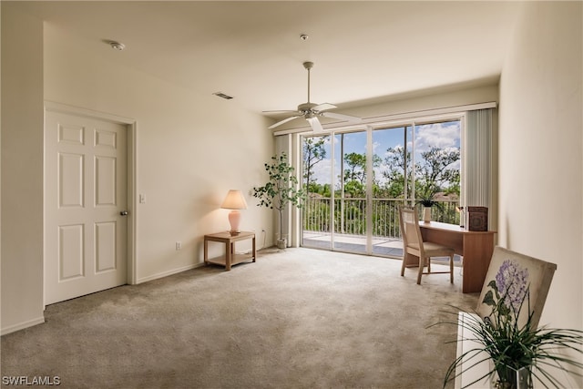 living area featuring carpet floors and ceiling fan