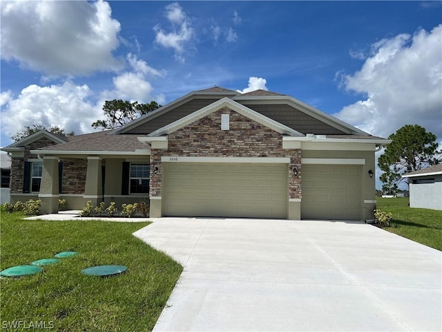 craftsman house featuring a garage and a front yard