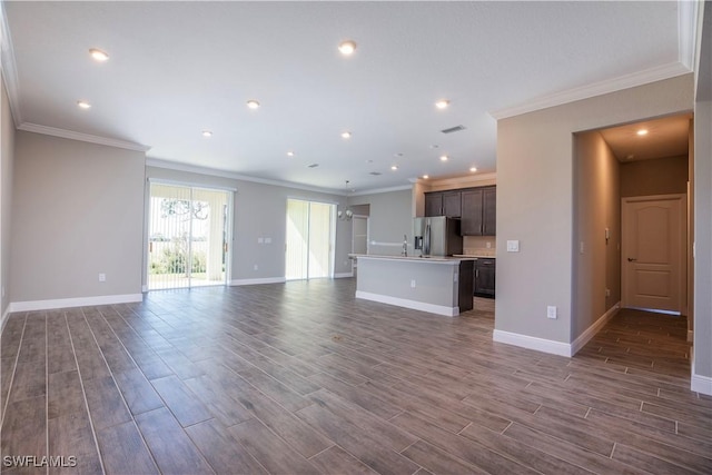 unfurnished living room with crown molding