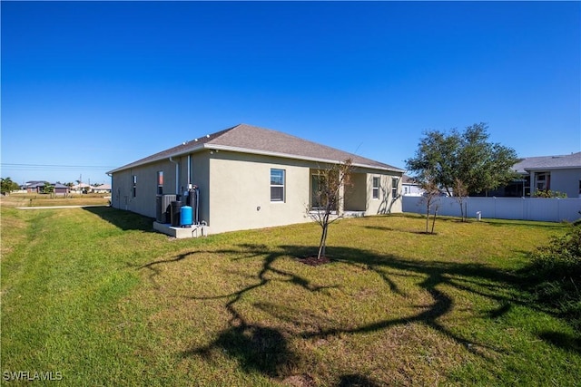 rear view of property featuring a yard