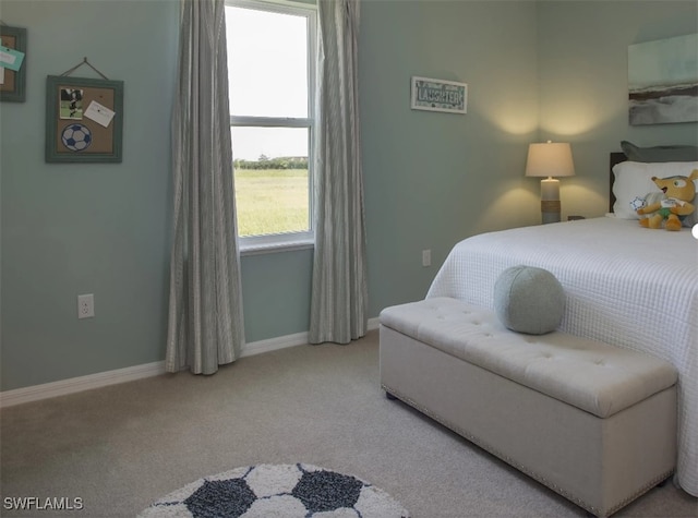 bedroom with multiple windows and carpet