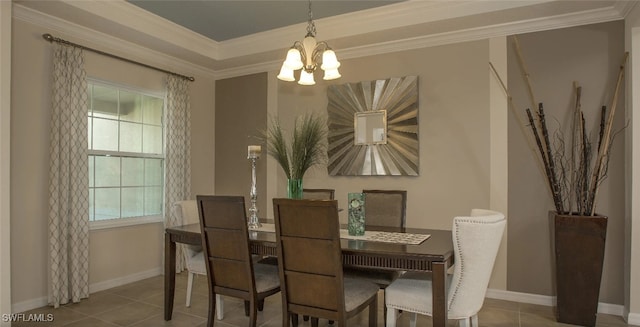 tiled dining room with an inviting chandelier, ornamental molding, and a raised ceiling