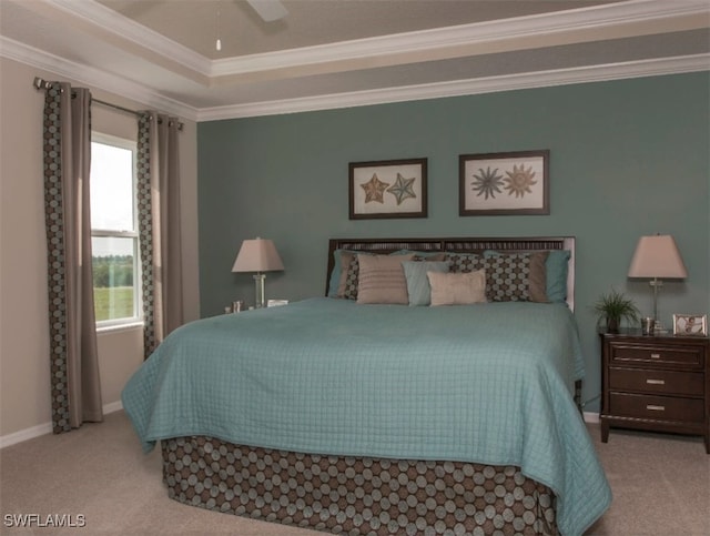 carpeted bedroom with crown molding, a raised ceiling, and ceiling fan