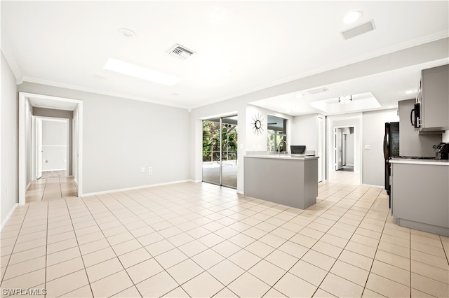 kitchen featuring sink, crown molding, and light tile floors