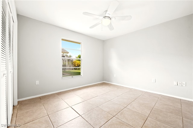 unfurnished bedroom featuring a closet, ceiling fan, and light tile floors