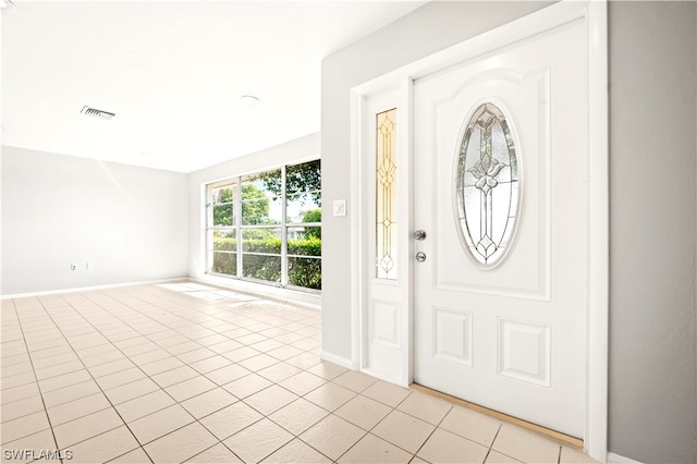 entrance foyer featuring light tile floors