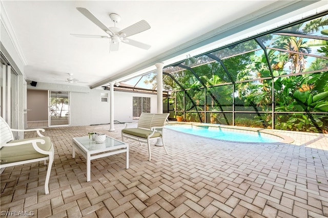 unfurnished sunroom with ceiling fan