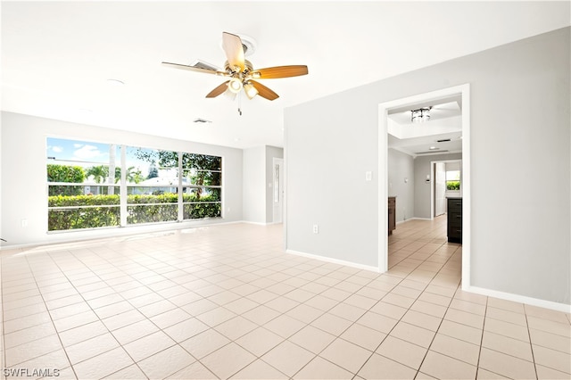 tiled empty room with ceiling fan