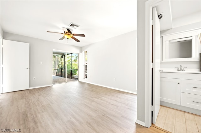 spare room featuring sink, ceiling fan, and light wood-type flooring