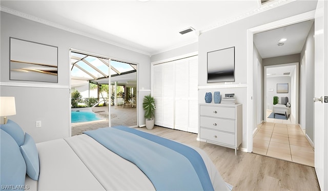 bedroom with a closet, crown molding, light tile floors, and access to outside