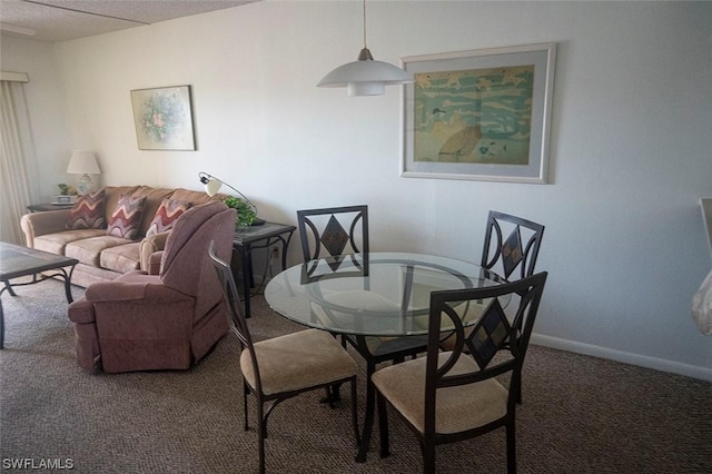 dining room with carpet and a textured ceiling