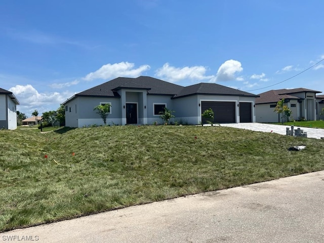 view of front of property featuring a front lawn and a garage