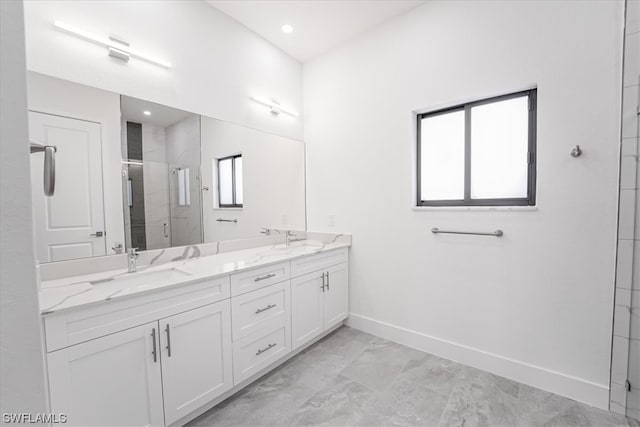 bathroom with plenty of natural light, dual sinks, oversized vanity, and tile flooring