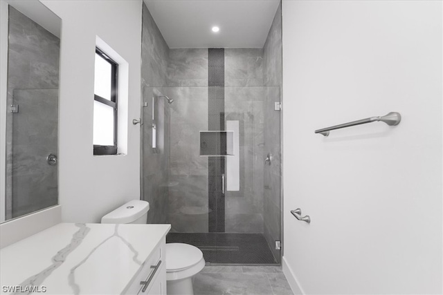 bathroom featuring toilet, tile flooring, vanity, and tiled shower