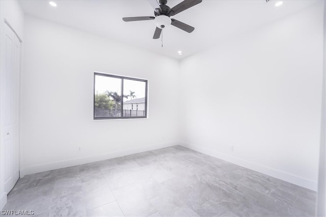 empty room featuring light tile floors and ceiling fan