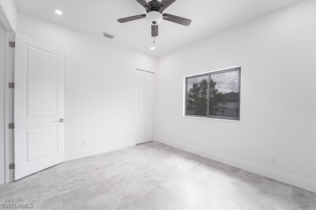 tiled empty room with ceiling fan