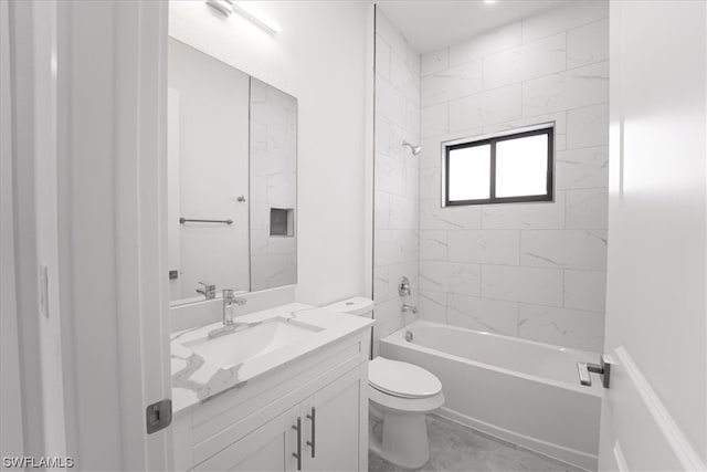 full bathroom with vanity, toilet, tile floors, and tiled shower / bath