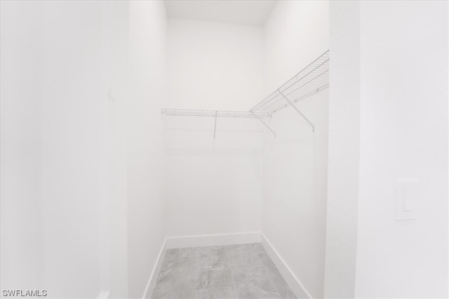 spacious closet featuring light tile flooring