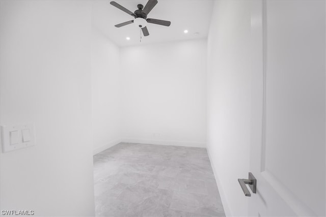 empty room featuring light tile floors and ceiling fan