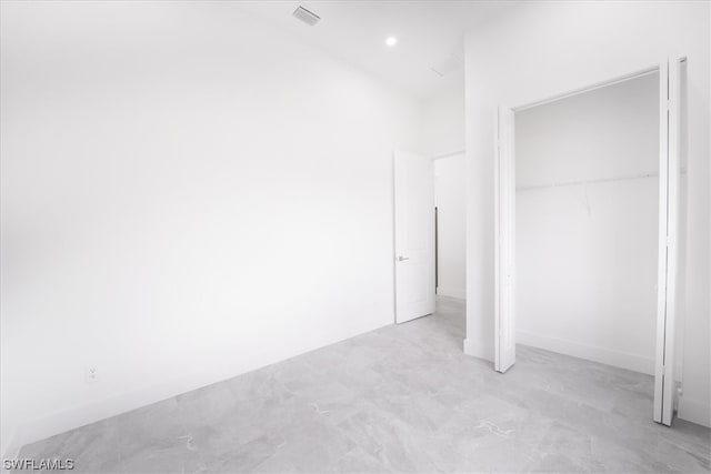 unfurnished bedroom with a closet and light tile flooring