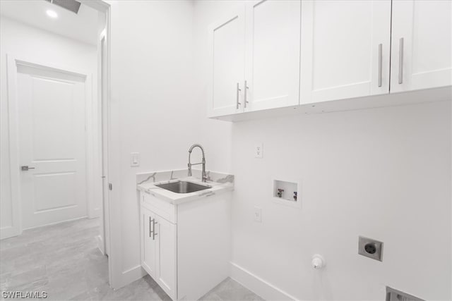 laundry area featuring light tile floors, electric dryer hookup, cabinets, and sink