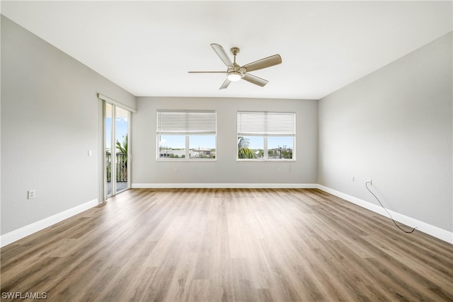 unfurnished room featuring ceiling fan and dark wood-type flooring