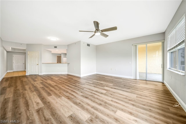 unfurnished living room with ceiling fan and light wood-type flooring