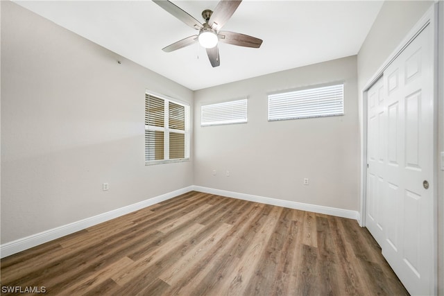 unfurnished bedroom with a closet, ceiling fan, and hardwood / wood-style flooring