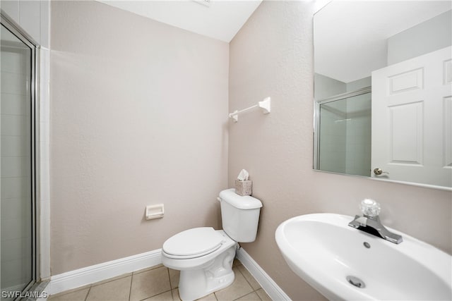 bathroom featuring toilet, tile flooring, walk in shower, and sink