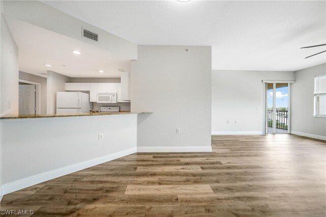 kitchen with light hardwood / wood-style floors, white appliances, ceiling fan, and white cabinets