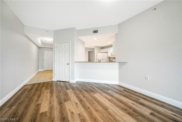 unfurnished living room featuring tile flooring