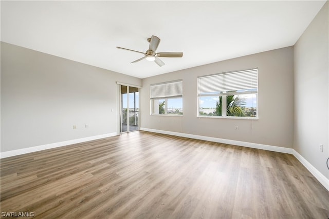 unfurnished room with ceiling fan and light wood-type flooring