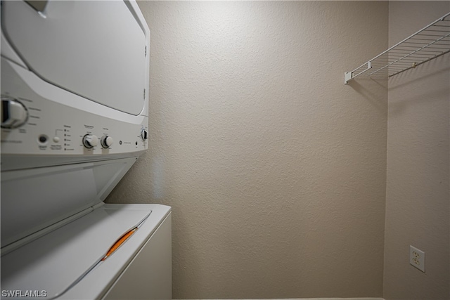 clothes washing area with stacked washer and clothes dryer