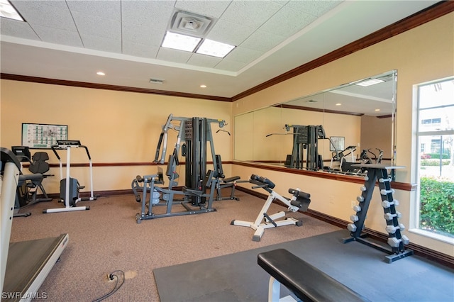 gym with ornamental molding and carpet