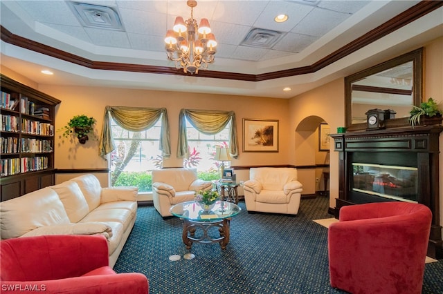 carpeted living room with crown molding, an inviting chandelier, and a tray ceiling