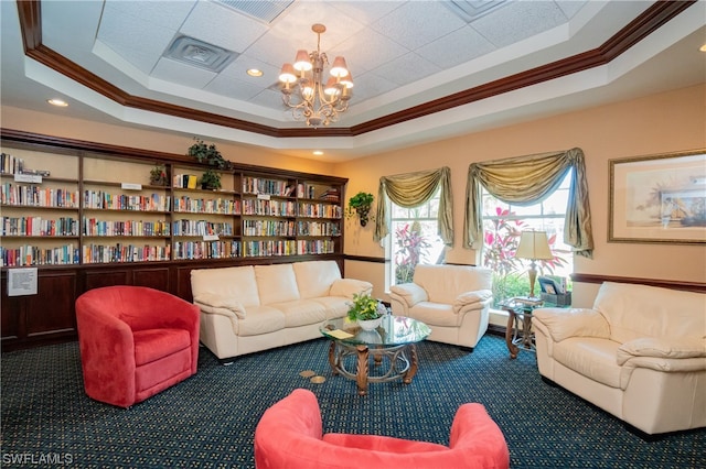 living room with a raised ceiling, a notable chandelier, and dark colored carpet