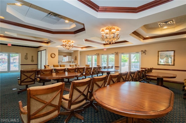 carpeted dining area featuring crown molding, an inviting chandelier, and a tray ceiling