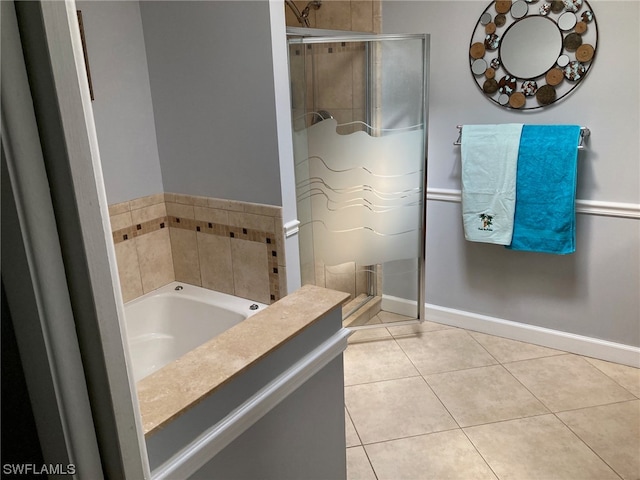 bathroom featuring separate shower and tub and tile flooring