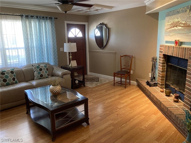 living room with a wealth of natural light, ceiling fan, light wood-type flooring, and a fireplace