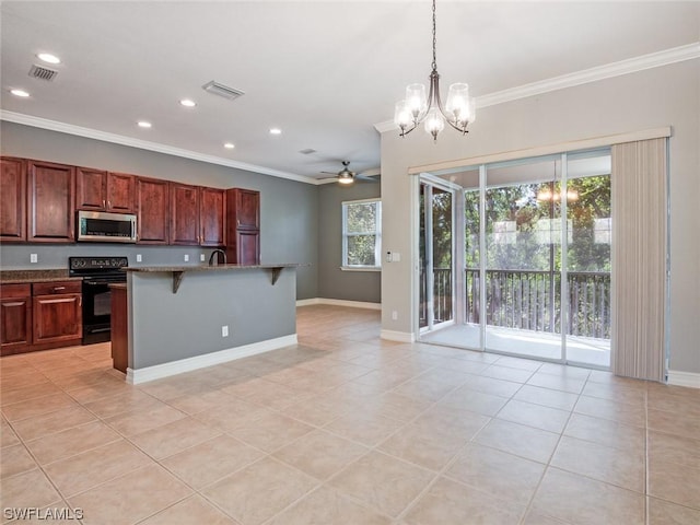 kitchen featuring a breakfast bar, black electric range, light tile patterned floors, pendant lighting, and a kitchen island with sink